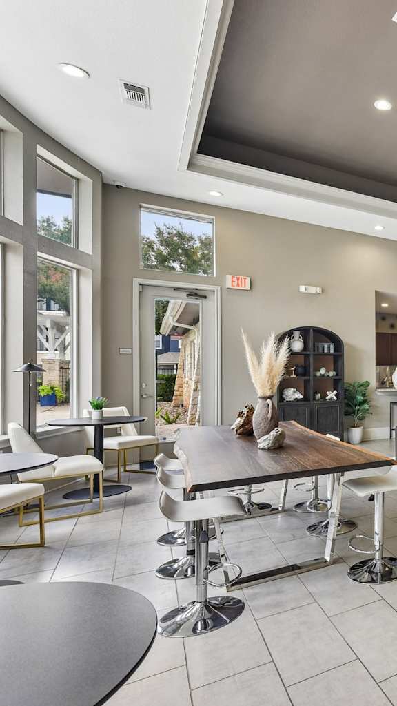A dining room with a white table and green chairs.