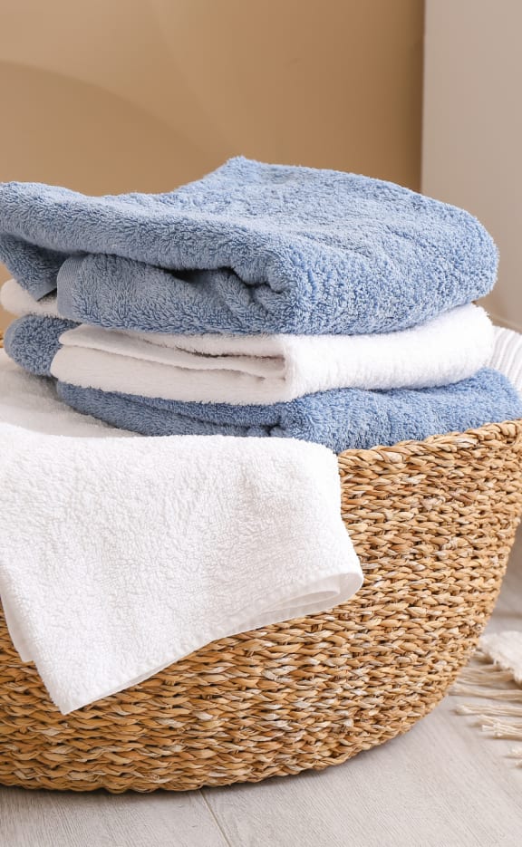 a basket full of towels in a bathroom