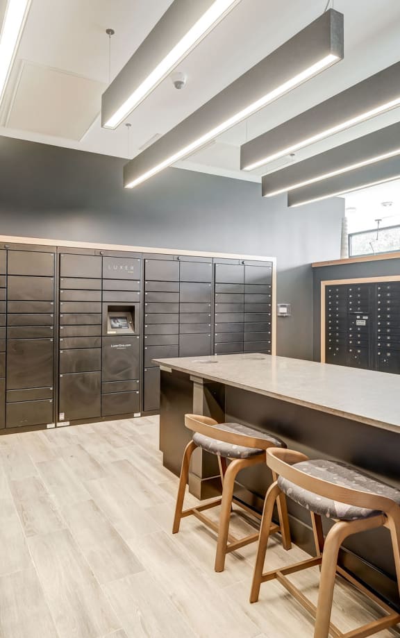 a large locker room with a long counter and three stools in front of it