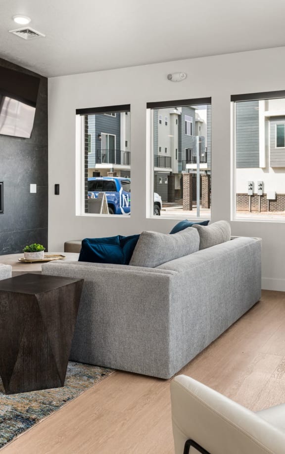 a living room with white furniture and a fireplace