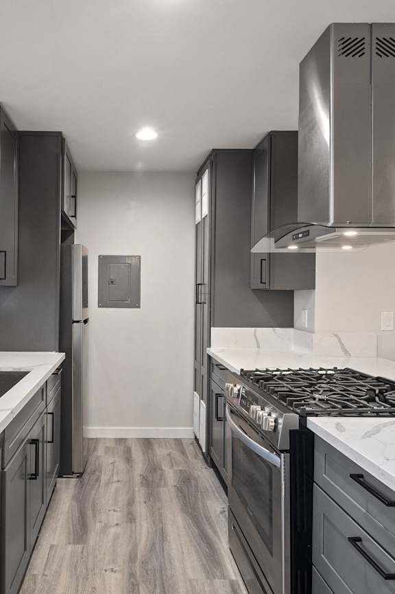 A modern kitchen with white cabinets and stainless steel appliances.