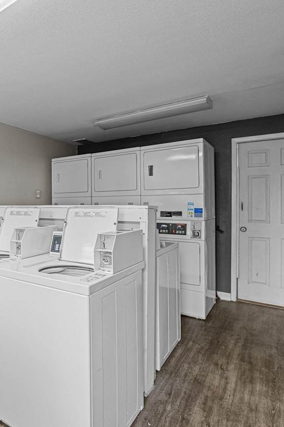 A laundry room with a washer and dryer stacked on top of each other.