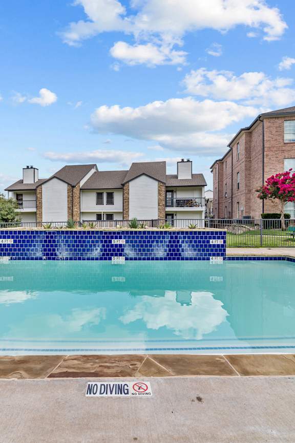 A pool with a blue divider and a sign that says "NO DIVING".