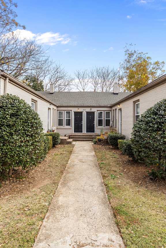 a white house with a sidewalk in front of it at Raleigh Rentals, North Carolina, 27604
