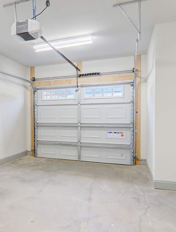 A garage with a white wall and a white door.