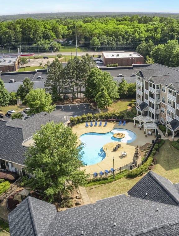 an aerial view of the resort style pool and hot tub at the reserve at south coast apartments