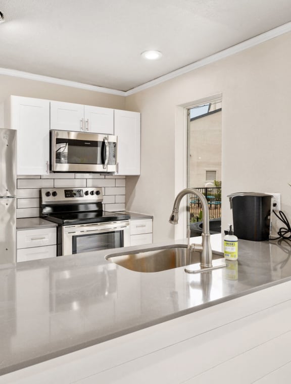 a large living room with a kitchen and a dining room