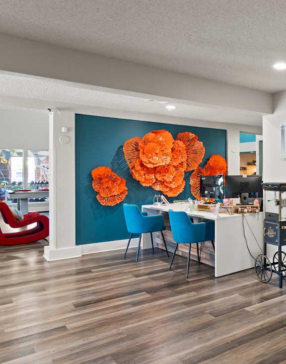 Leasing office with blue chairs and wall at Fusion Orlando apartments