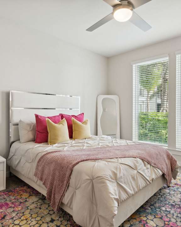 a bedroom with a bed and a painting on the wall  at Pinnacle Apartments, Jacksonville, FL, 32256