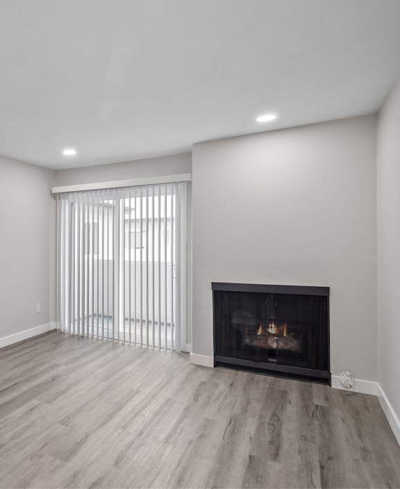 A modern kitchen with a dining area and a view of the balcony.