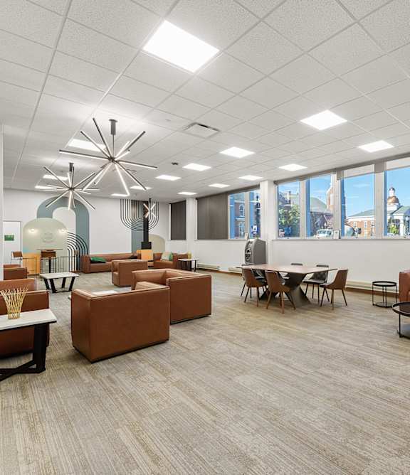 A modern office space with brown and orange furniture.
