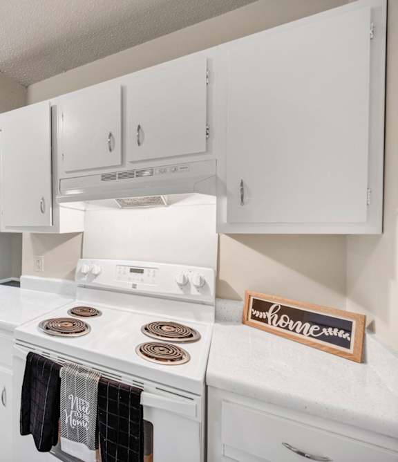 A kitchen with white appliances and wooden floors.at Peachtree Place, Columbia, 29210