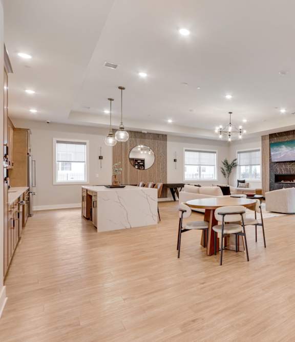 A spacious room with wooden floors and furniture.