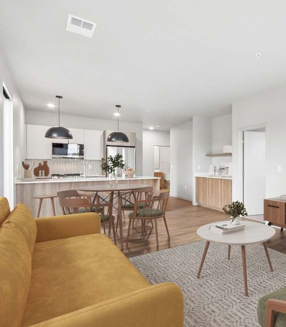 A living room with a round table and chairs.