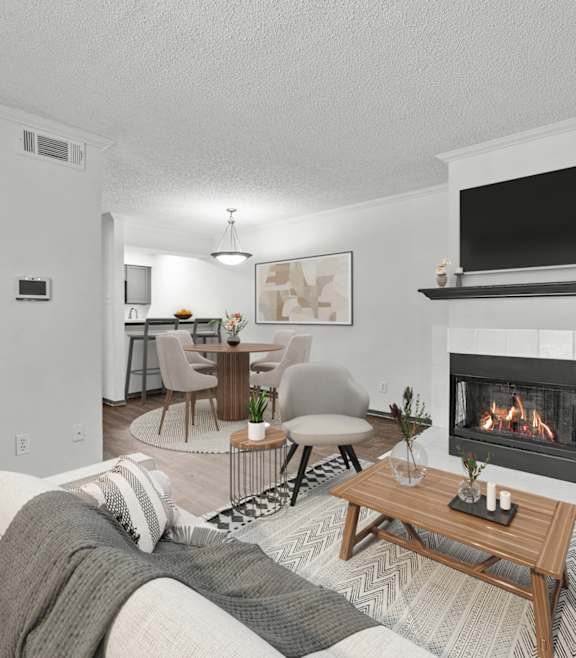 A modern living room with a fireplace and a television mounted above it.