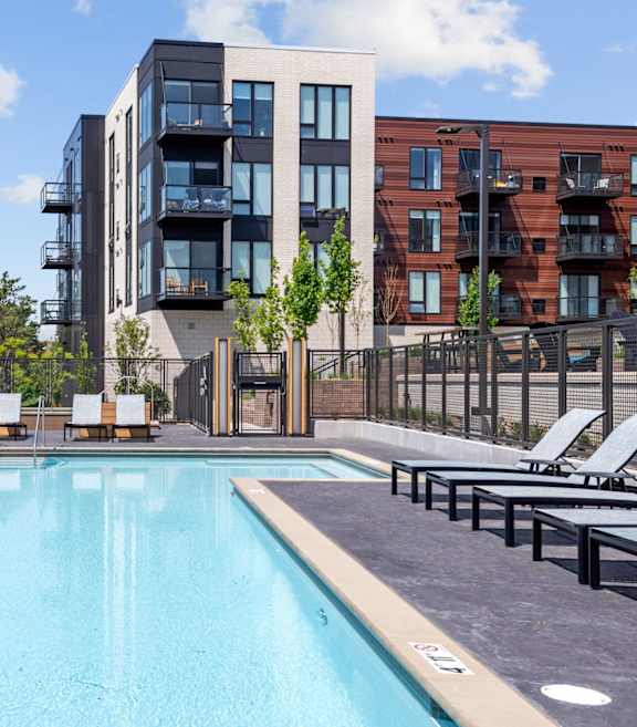A swimming pool in front of a modern building.