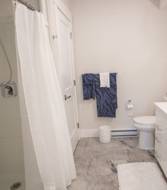 a small bathroom with a shower toilet and sink
