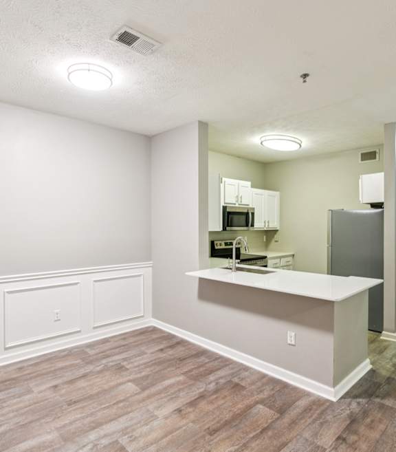 A white kitchen with a white oven and white cabinets.at The Atlantic Canton Ridge, Canton Georgia