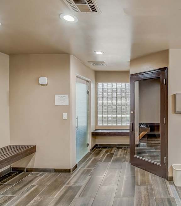 A bathroom with a wooden floor and a marble counter.