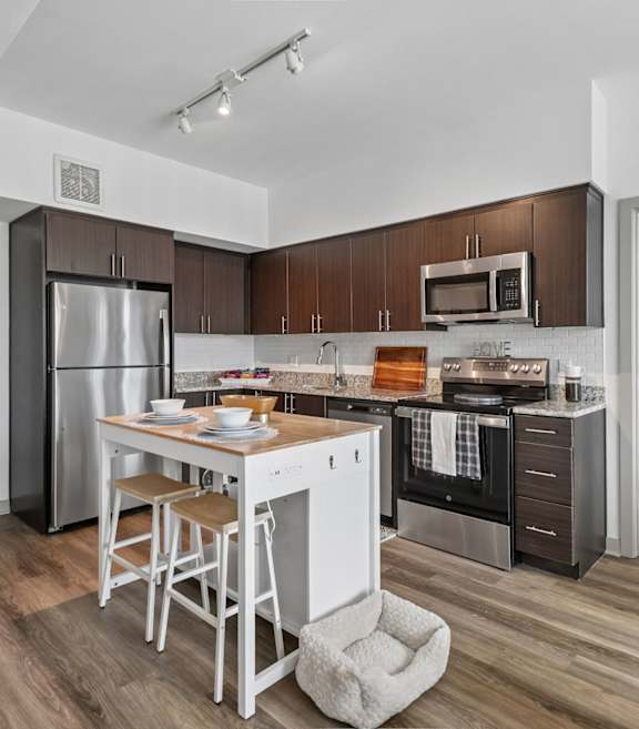 A kitchen with a white table and chairs.