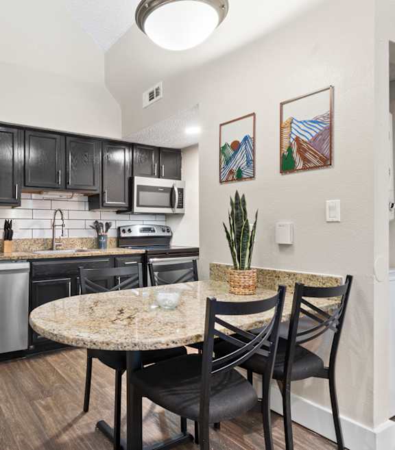 Fusion Orlando apartments kitchen with wood style plank flooring and stainless steel appliances.