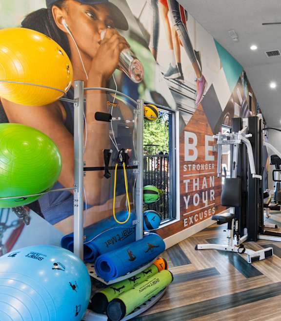 Fusion Orlando Apartments in Orlando, Fl. Fitness Center with free weights, exercise balls and cardio equipment.