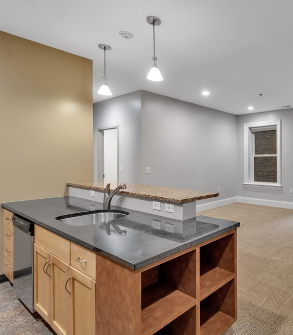 A kitchen with a sink and a counter at The Granite Works Apartments , Buffalo, NY