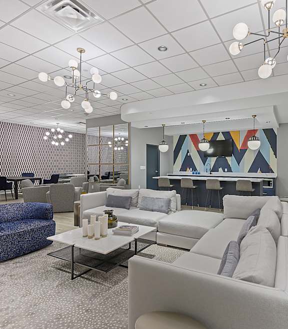 a living room filled with furniture and chandeliers