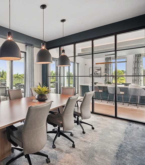 A conference room with a long table and chairs.