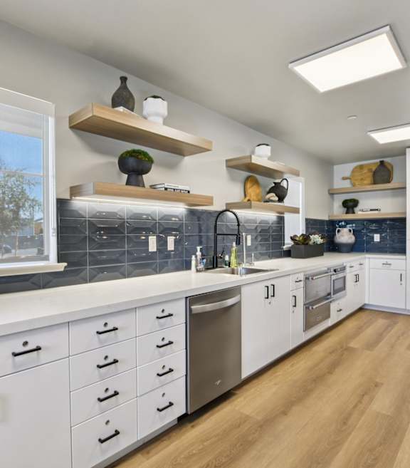 A modern kitchen with white cabinets at Terracina at Winding Creek, Roseville, CA