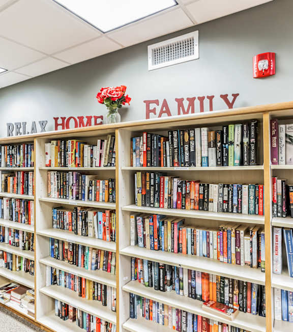 A bookshelf filled with books in a room.