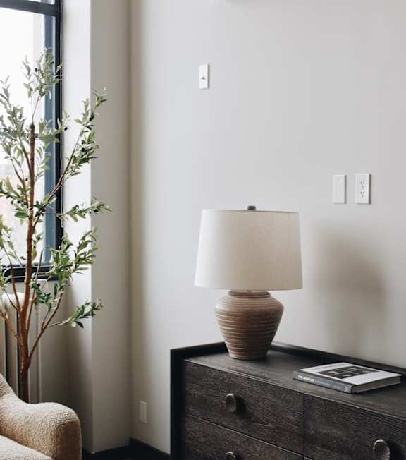 a bedroom with a bed and a shelving unit next to it