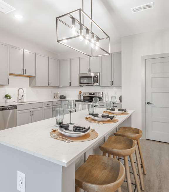A modern kitchen with a white countertop and stainless steel appliances. at Viridian Apartments LLC Apartments, Bowling Green
