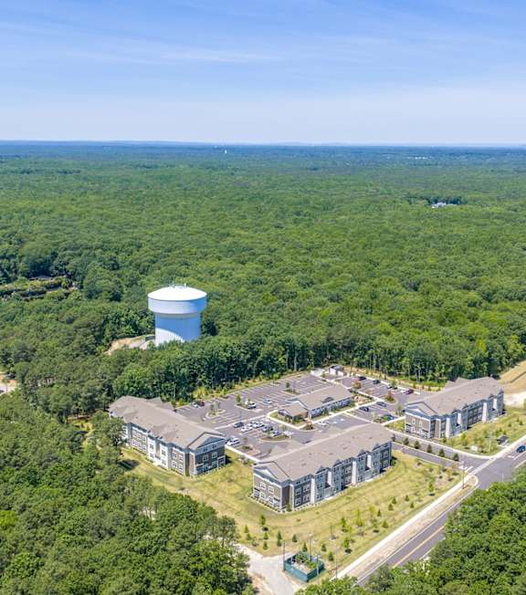 A large building complex surrounded by trees in autumn.