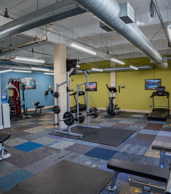 a gym with weights and other exercise equipment in a building