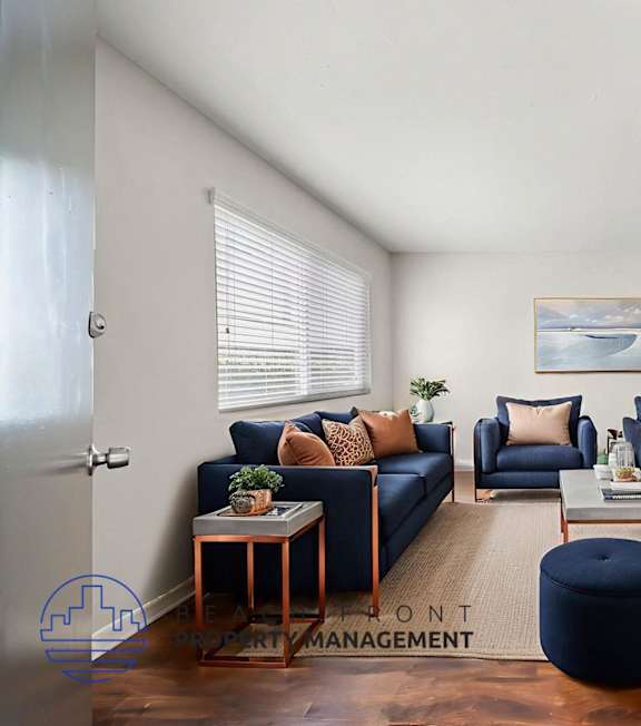 A well-lit, modern kitchen and living room with a dining area.