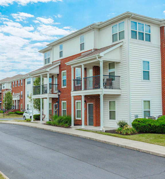 an empty street in front of an apartment building