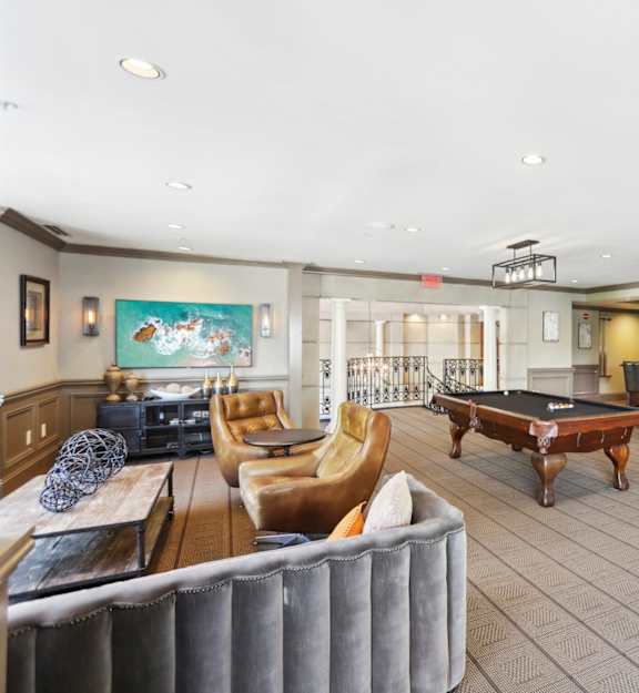 a game room with a pool table and couches