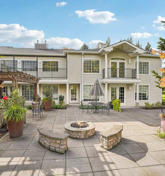 a patio with tables and umbrellas and a fire pit at Murrayhill Park, Oregon, 97008