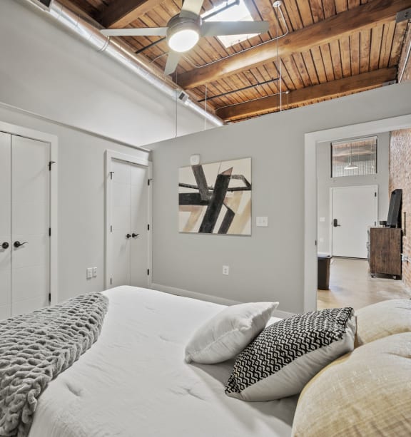 a bedroom with a large bed and a closet with a washer and dryer