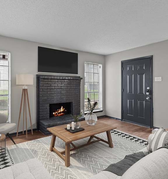 A modern living room with a fireplace and a flat screen TV mounted above it.