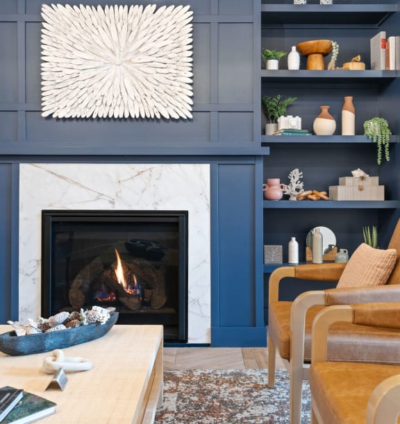 a living room with blue walls and a fireplace