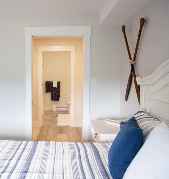 a bedroom with a bed and a closet and a bathroom