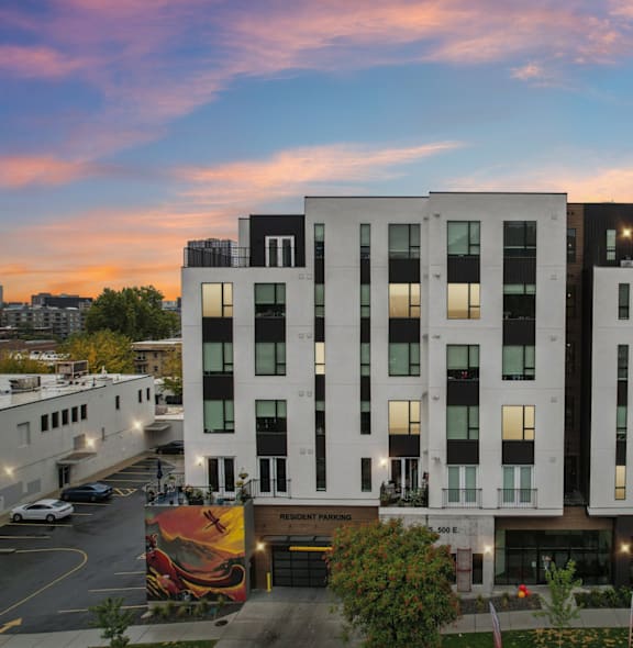 an aerial view of a building with a city in the background