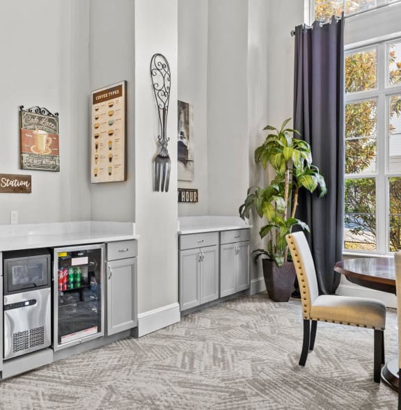 a kitchen with white cabinets and a counter top with a refrigerator