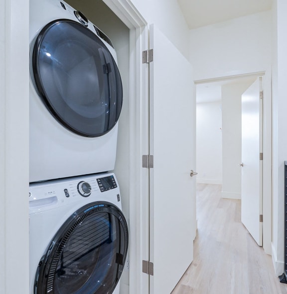 a front loading washer and dryer in a laundry room