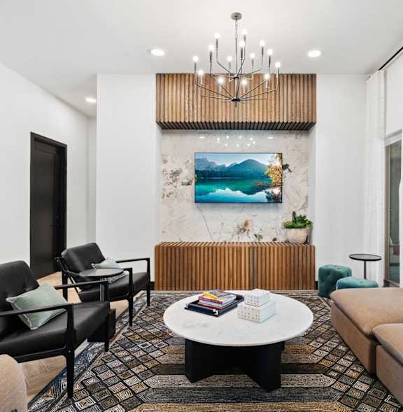 a living room with couches and chairs and a table