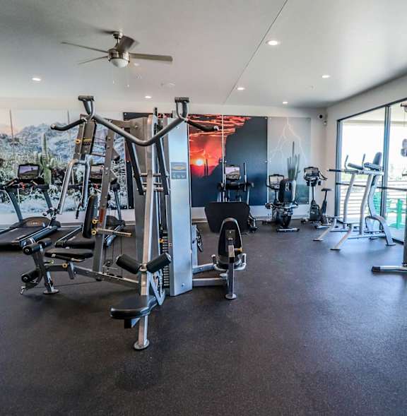 A gym with treadmills, a bench, and a weight machine.