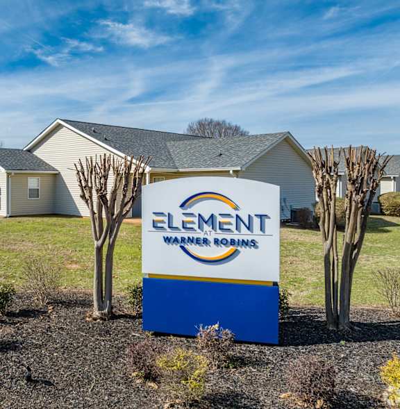 a sign in front of a house