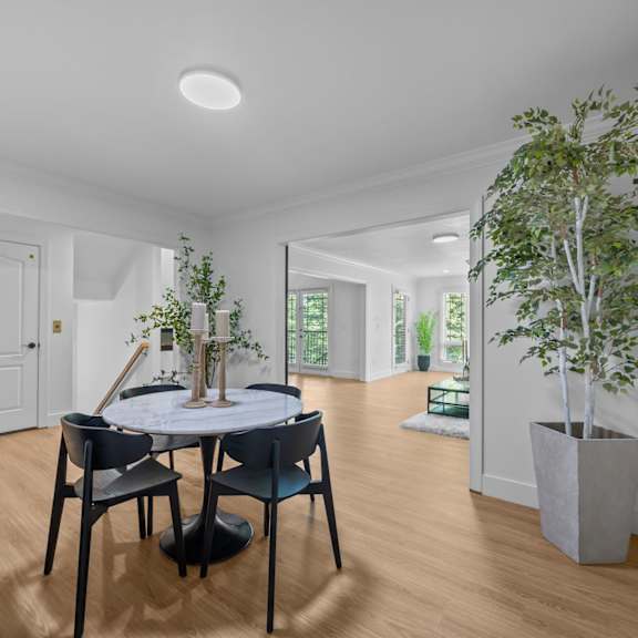 A dining room with a table and chairs.